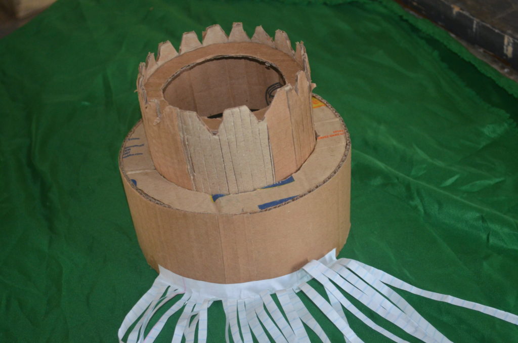 Participants creating caps from trash material
